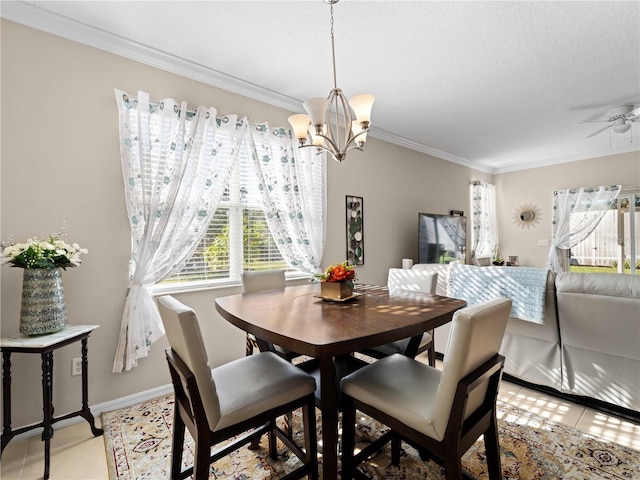 tiled dining area featuring crown molding, ceiling fan with notable chandelier, a textured ceiling, and a wealth of natural light