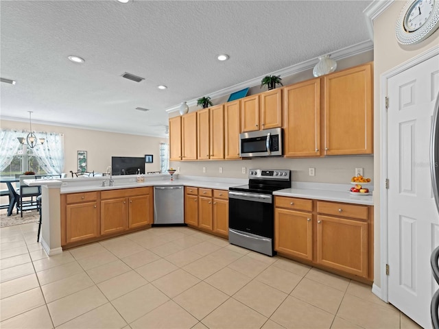 kitchen featuring pendant lighting, stainless steel appliances, ornamental molding, light tile patterned flooring, and kitchen peninsula