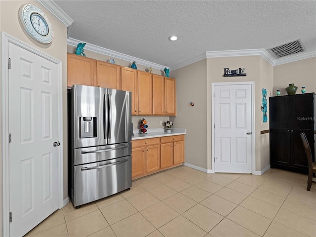 kitchen with light tile patterned floors, crown molding, a textured ceiling, and stainless steel refrigerator with ice dispenser