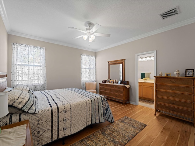 bedroom featuring connected bathroom, light wood-type flooring, ceiling fan, crown molding, and a textured ceiling