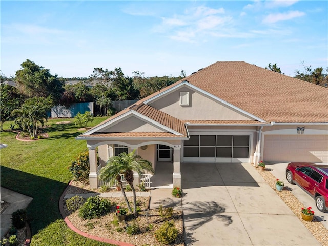 view of front of property featuring a garage and a front lawn