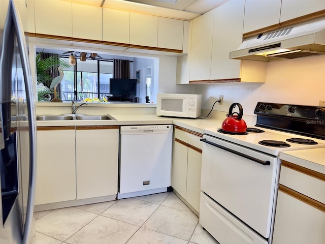 kitchen featuring white cabinetry, sink, light tile patterned floors, and white appliances