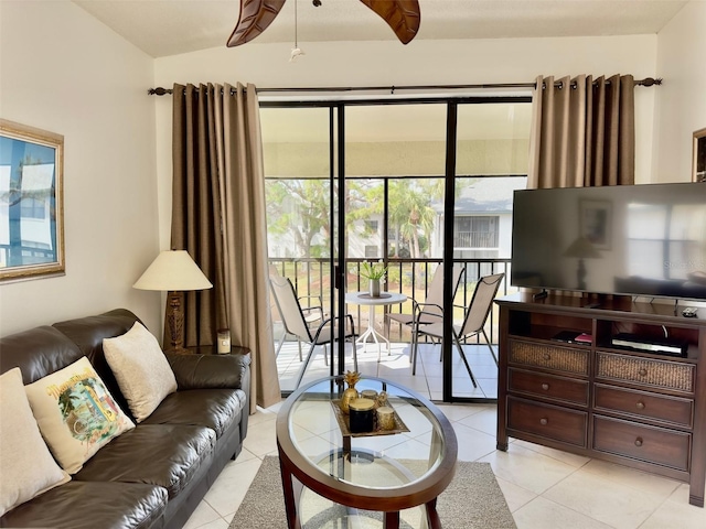 living room with light tile patterned flooring and vaulted ceiling