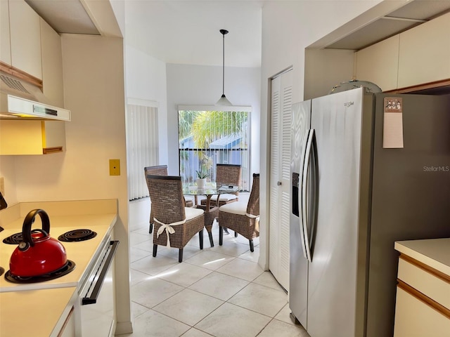 kitchen featuring light tile patterned flooring, white electric stove, white cabinetry, hanging light fixtures, and stainless steel fridge with ice dispenser