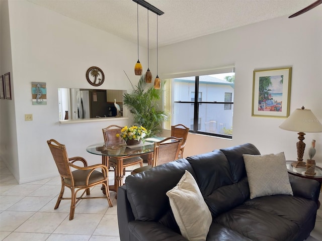 tiled living room featuring lofted ceiling and a textured ceiling