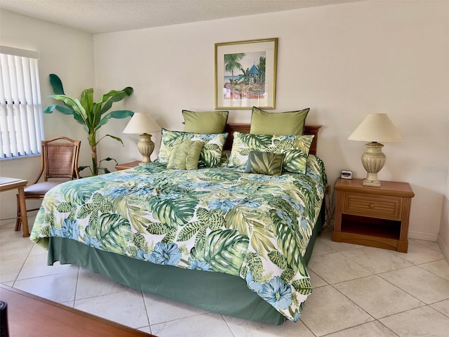 bedroom with light tile patterned floors and a textured ceiling