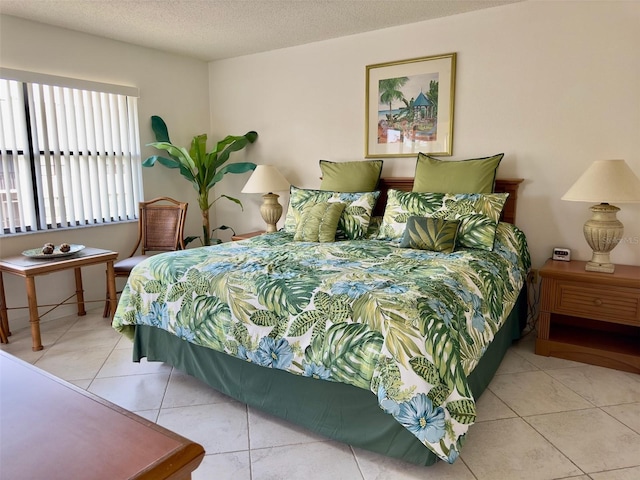 tiled bedroom featuring a textured ceiling