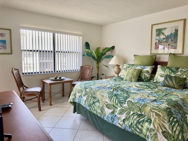 tiled bedroom featuring a textured ceiling