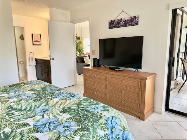 tiled bedroom featuring ensuite bath