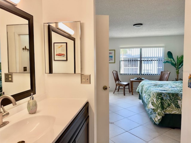 bathroom with vanity, tile patterned floors, and a textured ceiling