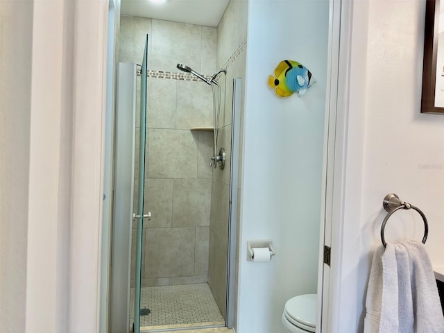 bathroom featuring walk in shower and toilet