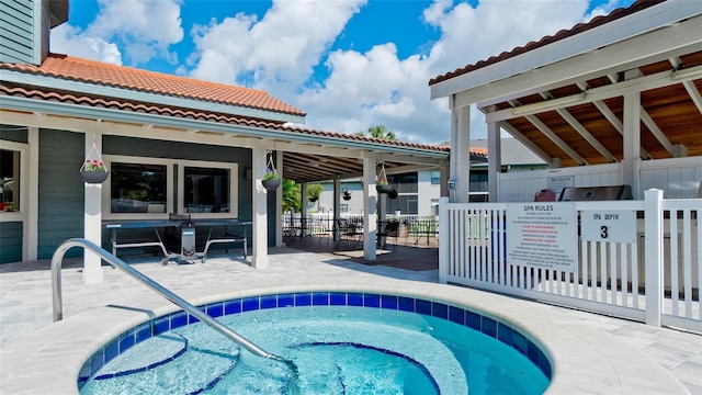 view of pool featuring a hot tub and a patio