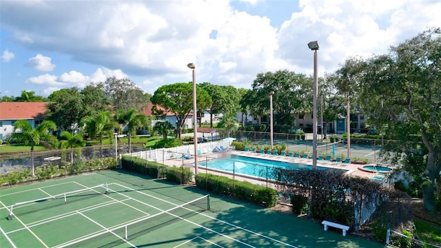 view of sport court featuring a community pool