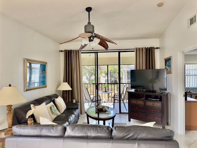 tiled living room with ceiling fan and vaulted ceiling