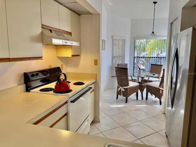 kitchen with hanging light fixtures, light tile patterned floors, stainless steel refrigerator, white range with electric stovetop, and exhaust hood