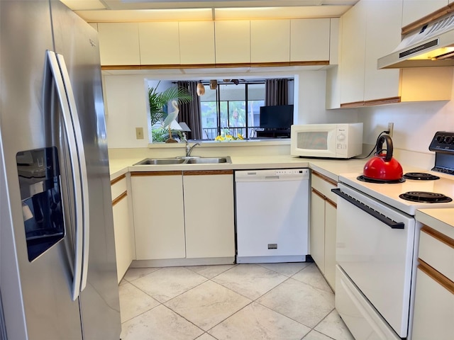 kitchen with sink, white appliances, light tile patterned floors, and white cabinets