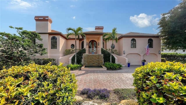 mediterranean / spanish-style home with a garage