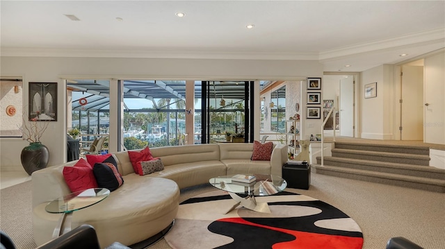 living room with carpet floors, a wealth of natural light, and ornamental molding