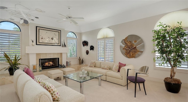 living room featuring ceiling fan, carpet flooring, and a tile fireplace