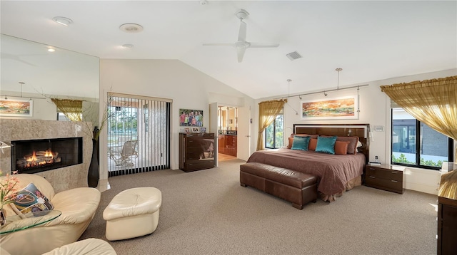 bedroom with light carpet, multiple windows, lofted ceiling, and a premium fireplace