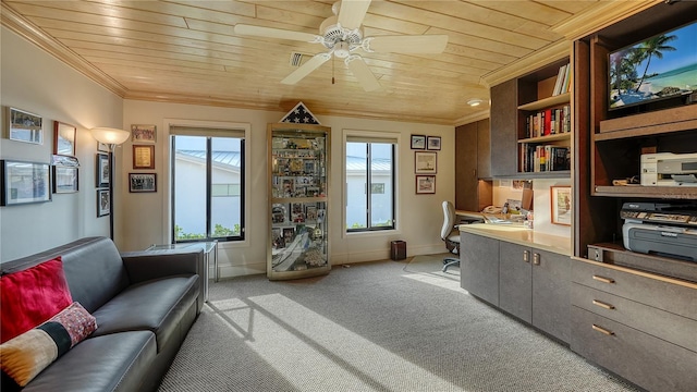 carpeted home office featuring crown molding, built in desk, ceiling fan, and wood ceiling