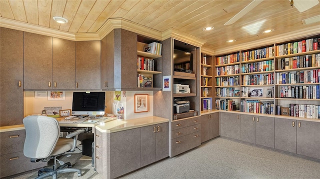 carpeted office with crown molding, wood ceiling, and built in shelves