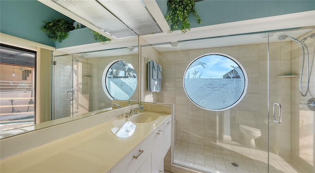 bathroom with vanity, tile walls, and an enclosed shower