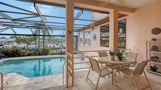 view of swimming pool featuring a lanai and a patio