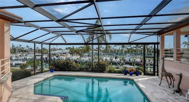 view of swimming pool with a water view, a lanai, and a patio area