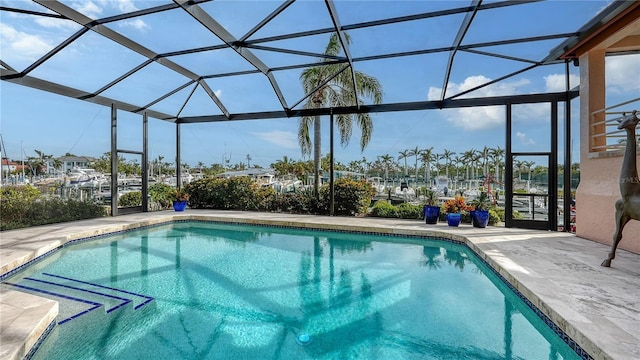 view of swimming pool with a patio and glass enclosure