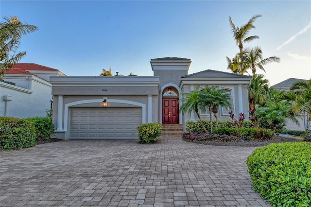 mediterranean / spanish-style house with a garage