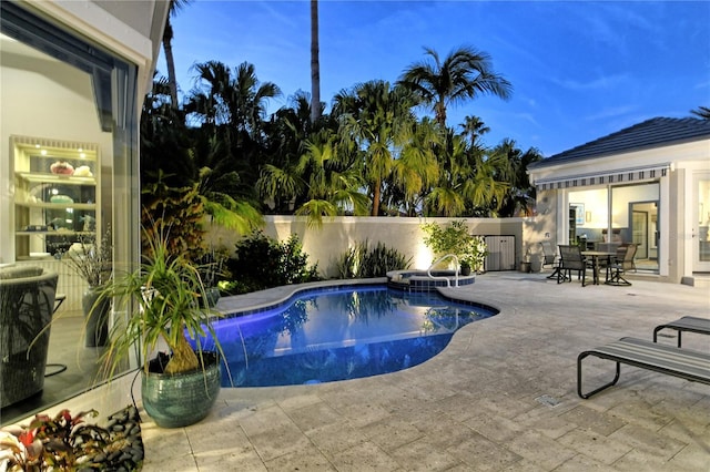 pool at dusk with a patio