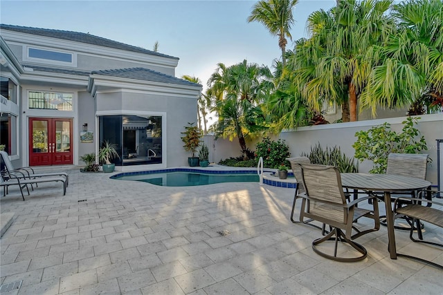 view of swimming pool with a patio and french doors