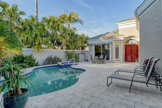 view of pool featuring an in ground hot tub and a patio area