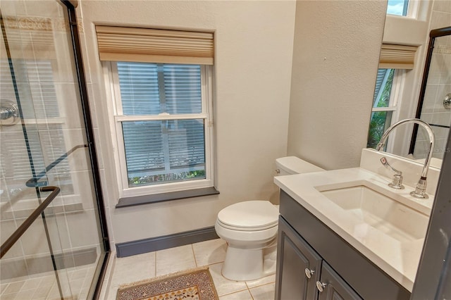 bathroom featuring vanity, tile patterned floors, toilet, and walk in shower