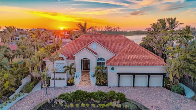400 N Washington Dr, Sarasota, FL 34236 - mediterranean / spanish-style home with a tiled roof, an attached garage, decorative driveway, and stucco siding