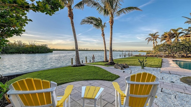 400 N Washington Dr, Sarasota, FL 34236 - patio terrace at dusk featuring a water view and a lawn