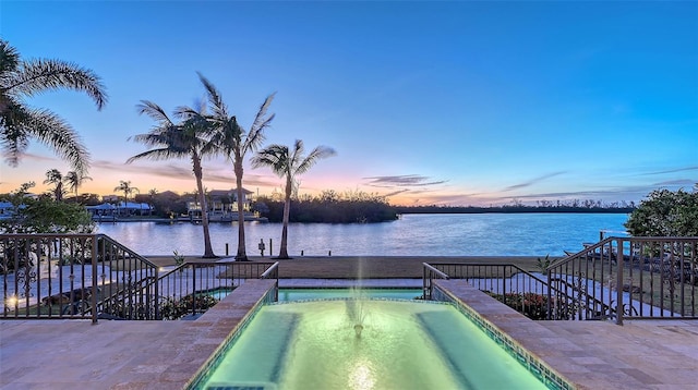 400 N Washington Dr, Sarasota, FL 34236 - pool at dusk featuring a water view and a pool with connected hot tub