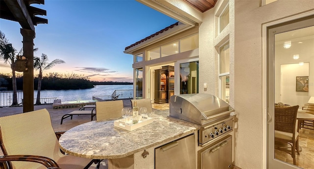 400 N Washington Dr, Sarasota, FL 34236 - patio terrace at dusk featuring a water view and outdoor dining space