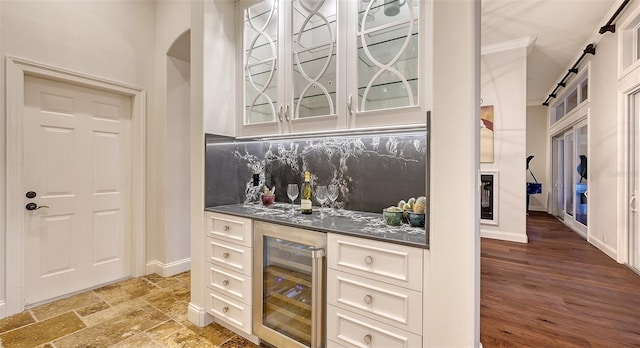 400 N Washington Dr, Sarasota, FL 34236 - indoor dry bar featuring beverage cooler, tasteful backsplash, baseboards, a barn door, and ornamental molding