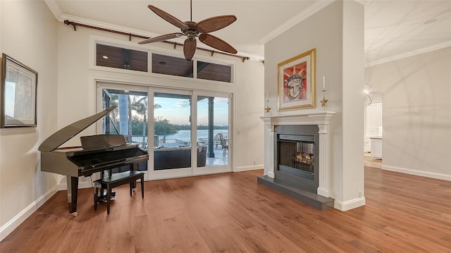 400 N Washington Dr, Sarasota, FL 34236 - living room with crown molding, wood finished floors, a ceiling fan, baseboards, and a multi sided fireplace