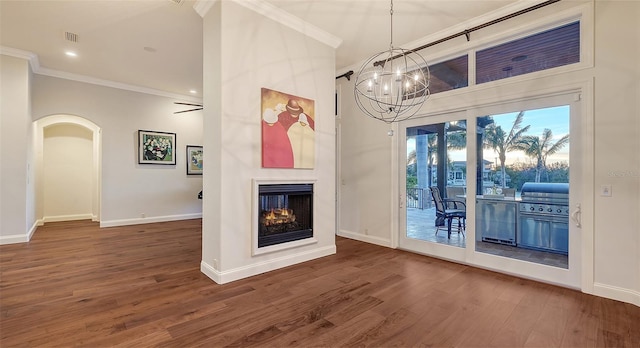 400 N Washington Dr, Sarasota, FL 34236 - unfurnished living room with ornamental molding, baseboards, wood finished floors, a chandelier, and a multi sided fireplace
