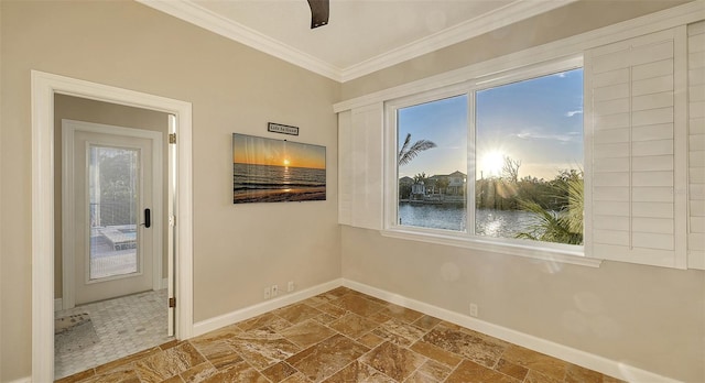 400 N Washington Dr, Sarasota, FL 34236 - spare room with stone tile floors, baseboards, crown molding, healthy amount of natural light, and a water view