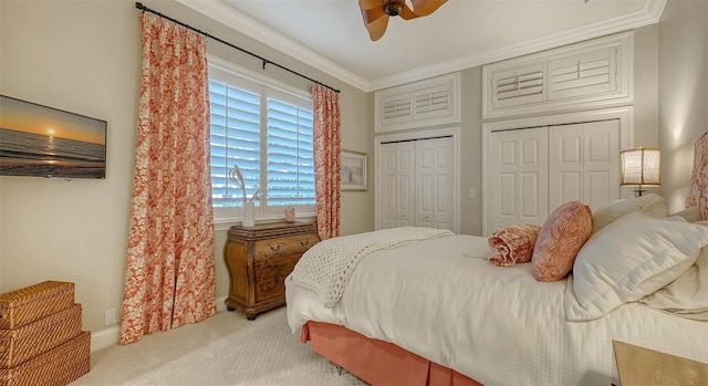 400 N Washington Dr, Sarasota, FL 34236 - carpeted bedroom with two closets, ornamental molding, and a ceiling fan