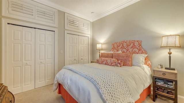 400 N Washington Dr, Sarasota, FL 34236 - bedroom featuring light colored carpet, multiple closets, and crown molding