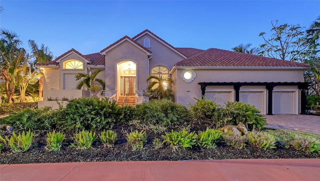 400 N Washington Dr, Sarasota, FL 34236 - mediterranean / spanish-style house featuring stucco siding, decorative driveway, and an attached garage