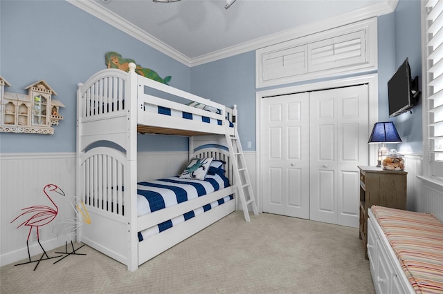 400 N Washington Dr, Sarasota, FL 34236 - bedroom featuring a wainscoted wall, ornamental molding, carpet flooring, and a closet