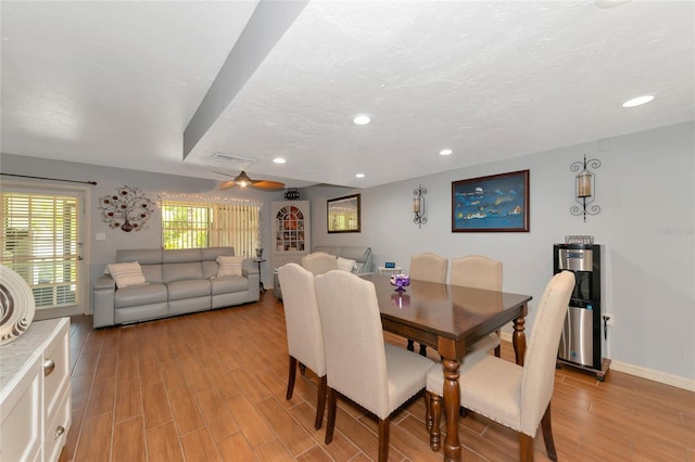 dining space featuring ceiling fan, a textured ceiling, and light hardwood / wood-style flooring