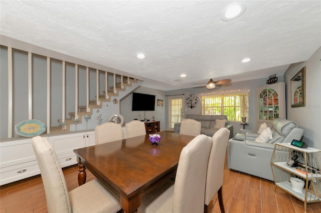 dining room featuring ceiling fan and a textured ceiling