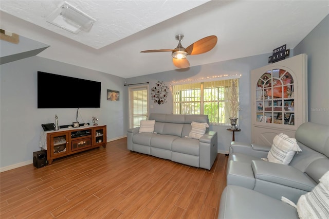 living room with ceiling fan and light hardwood / wood-style floors